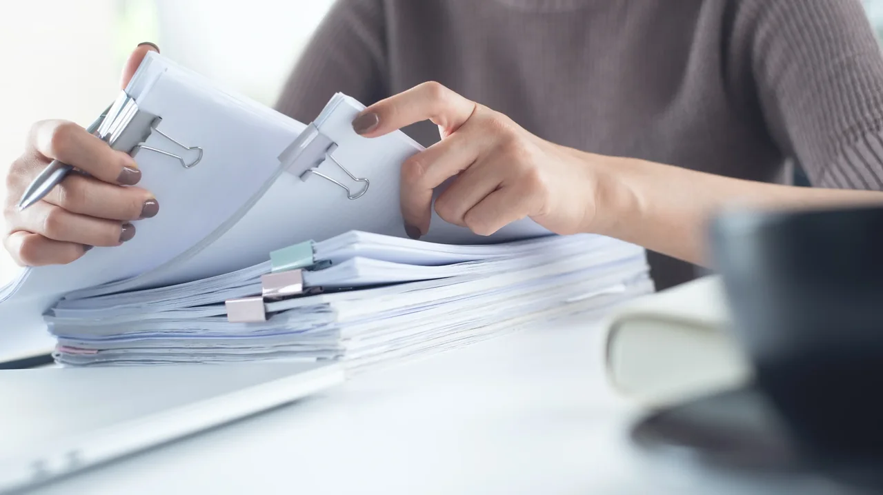 Pioneer Translations translation services Printed records being checked for document translation services